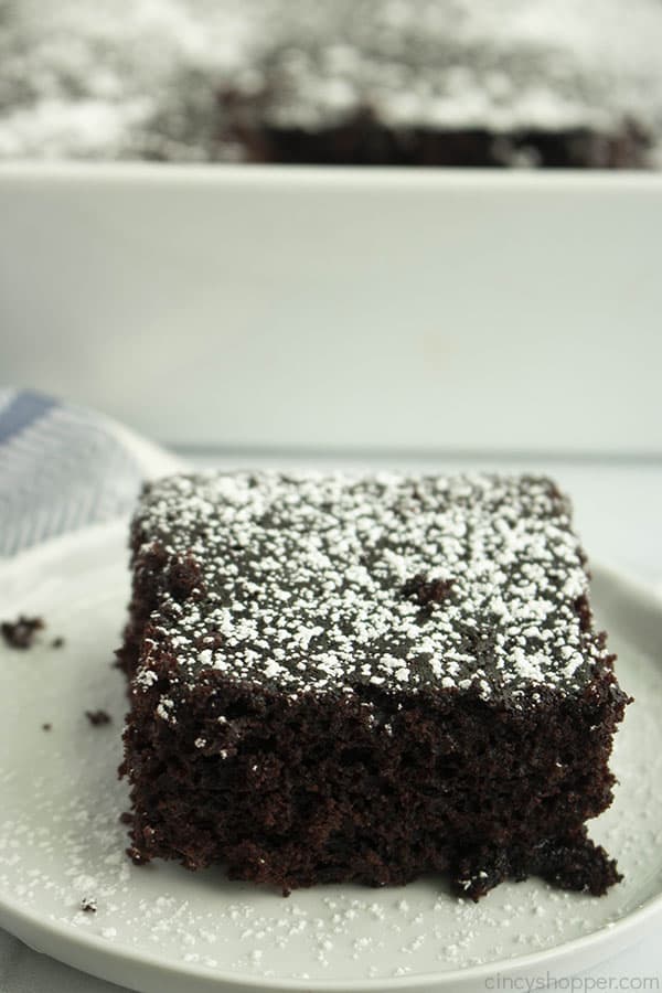 square slice of chocolate depression cake with powdered sugar on top