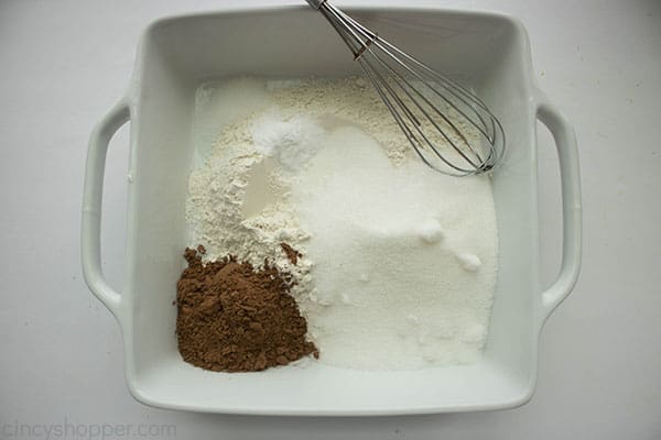 whisking flour, cocoa powder, salt, and sugar in a square baking dish