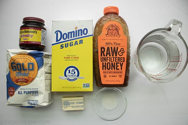 ingredients to make homemade bread - flour, sugar, yeast, honey, butter, water