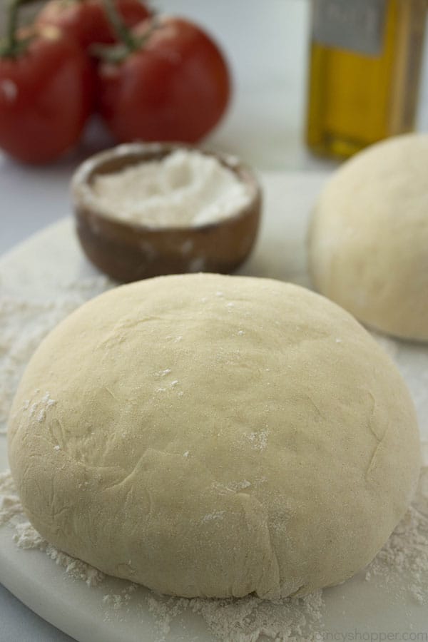 Homemade Pizza Dough ball on floured surface.