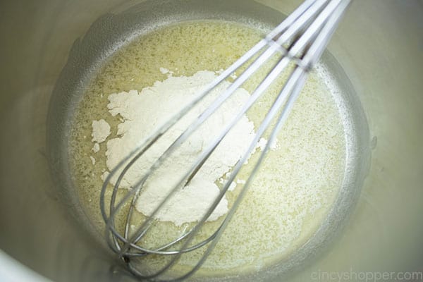 melted butter and flour in a pot with a metal whisk