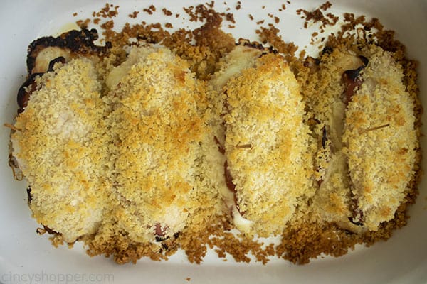 cooked stuffed chicken with browned breadcrumbs in a casserole dish