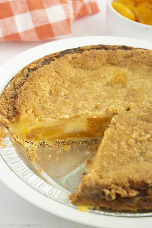 Fresh baked pie with peaches and custard in a pie tin