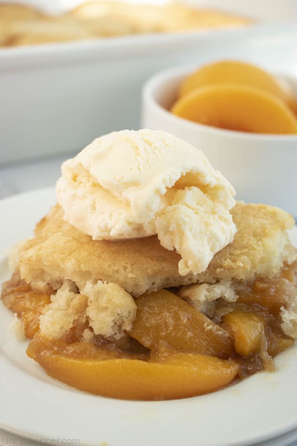 Peach Cobbler with Canned Peaches on a plate with scoop of ice cream