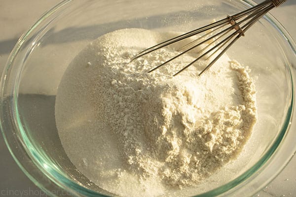 Flour, sugar, baking powder in a mixing bowl.