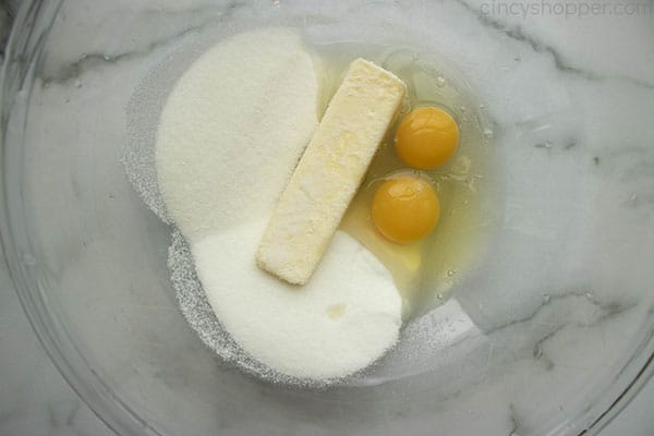 Eggs, butter, sugar, and vanilla in a clear mixing bowl