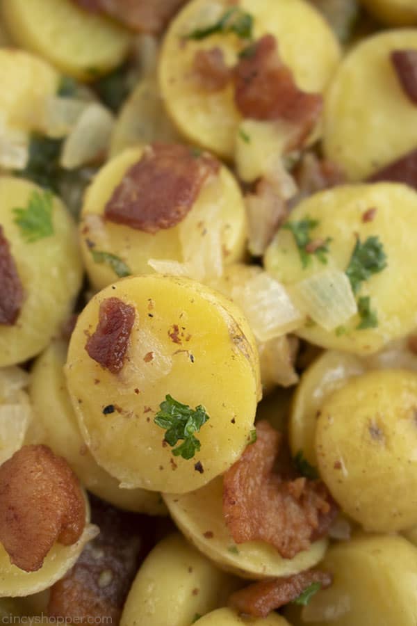 Close up: cooked potatoes with onion, bacon, and fresh parsley