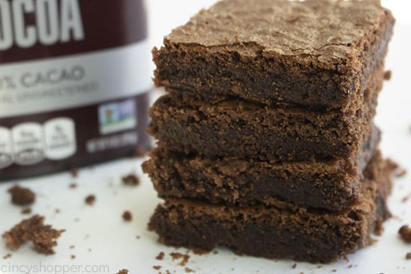 stack of 4 Hershey cocoa brownies next to a box of Hershey's cocoa powder