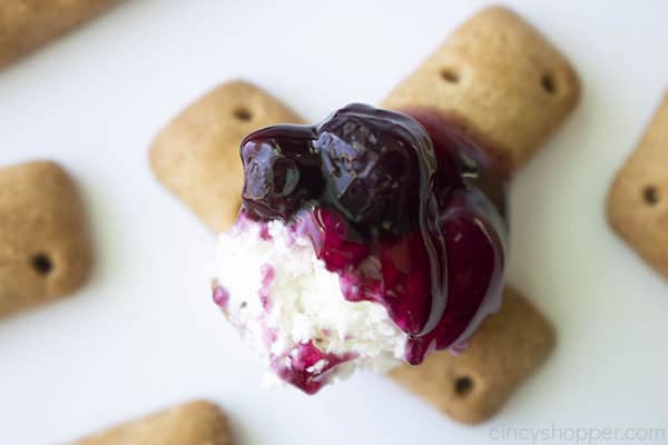 Two graham cracker sticks with blueberry cheesecake dip