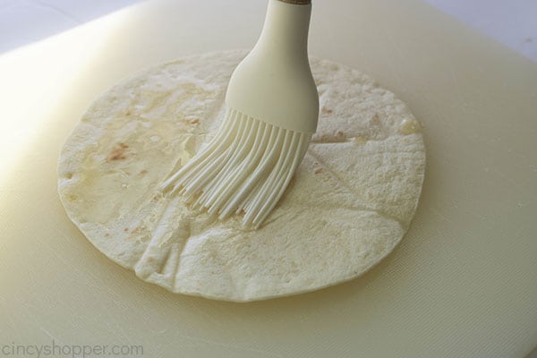 White brush with butter on flour tortilla 