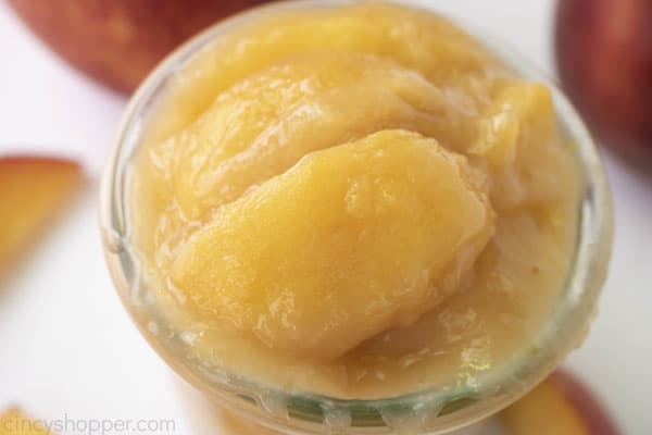 Overflowing glass jar with fresh cooked peach pie filling