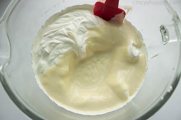 Combined whipping cream and cream cheese mixture with a spatula