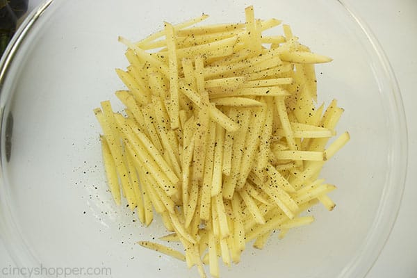 Dried potatoes in a clear bowl with seasonings