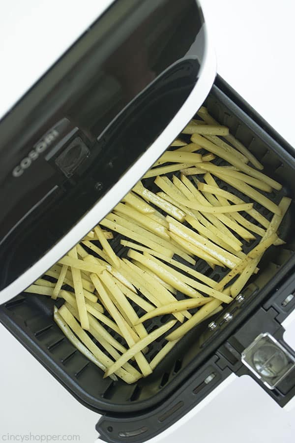 Raw potatoes in a white air fryer