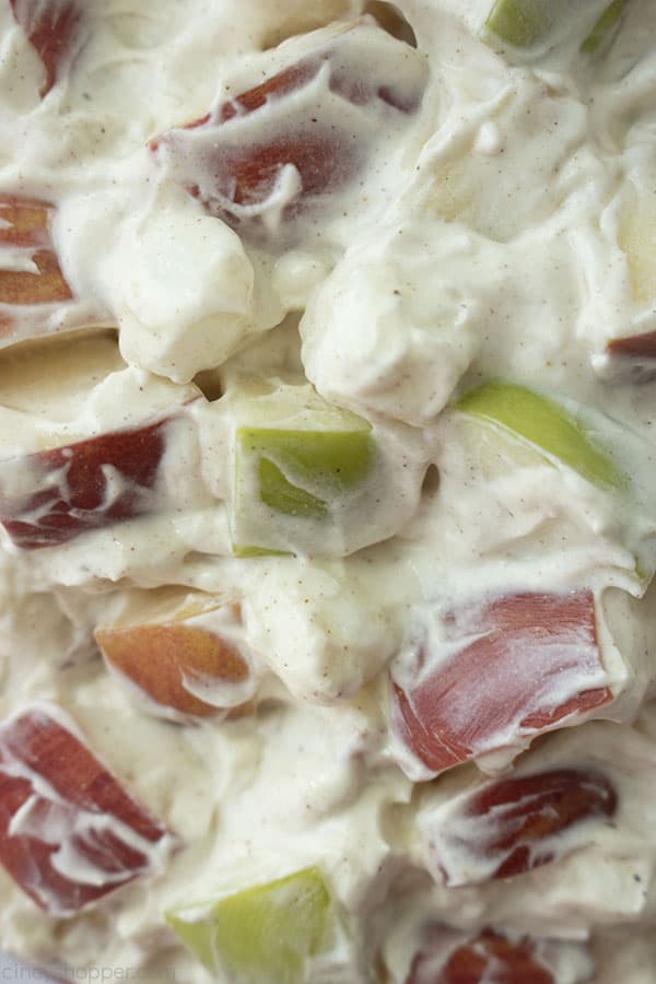Close up shot of just the Creamy Apple Salad with red and green cut up apple pieces showing through 