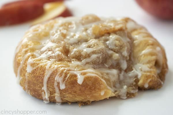 Danish with apple and crumb topping on a white background