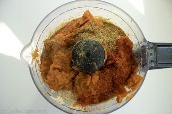 Canned pumpkin, cumin, some cayenne pepper, and paprika added to food processor.