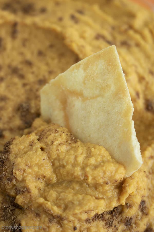 Closeup of Pita Chip dipped inside of Pumpkin Hummus.