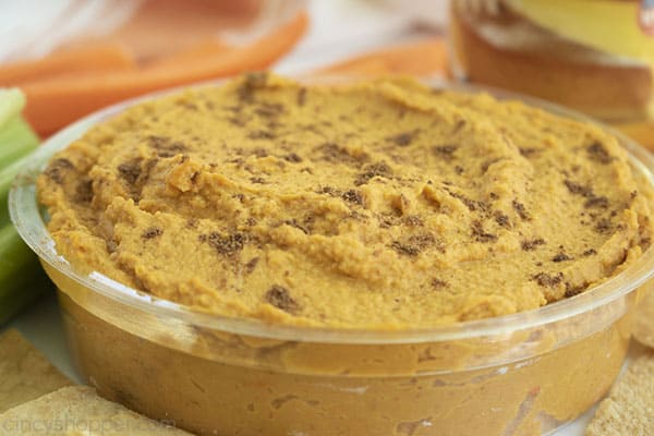 Sideways shot of finished hummus dip in a clear bowl