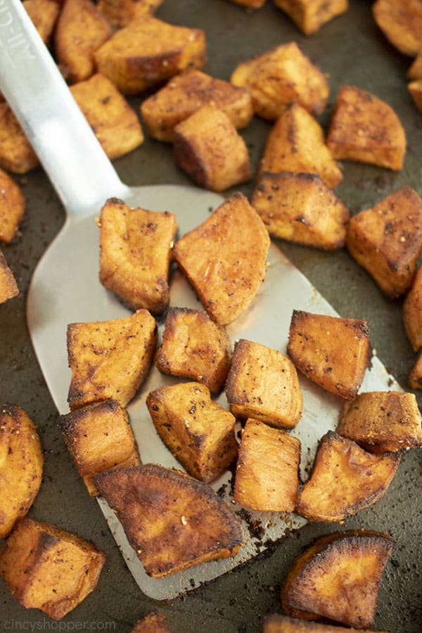 Roasted Garlic Sweet Potatoes on a stainless spatula. 