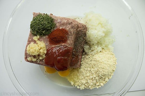 Classic Meatloaf ingredients in a large clear bowl.