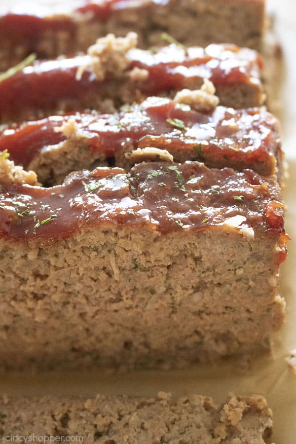 Slices of tangy glazed meatloaf on brown parchment paper.