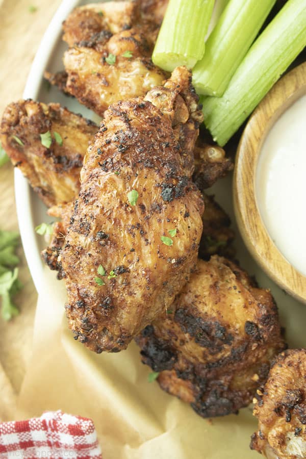 Air Fried Chicken Wings on a white plate with blue cheese and celery