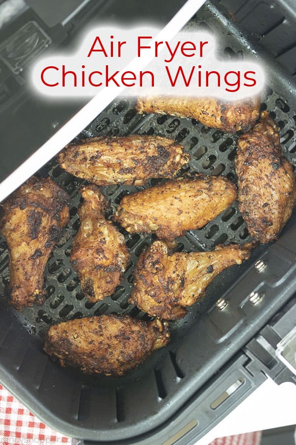 Cooked wings in air fryer with text on image Air Fryer Chicken Wings