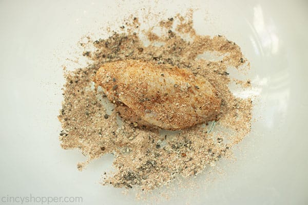 Chicken wing in clear bowl with rub