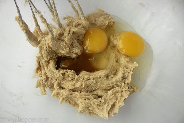 Muffin mixture with eggs and vanilla in bowl with mixing beaters.