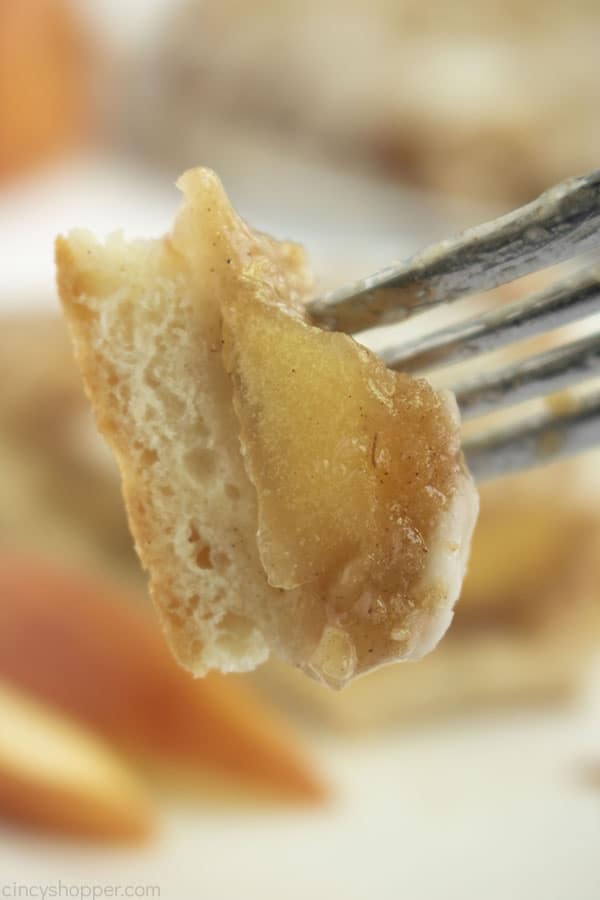 Closeup of apple pizza dessert on a fork