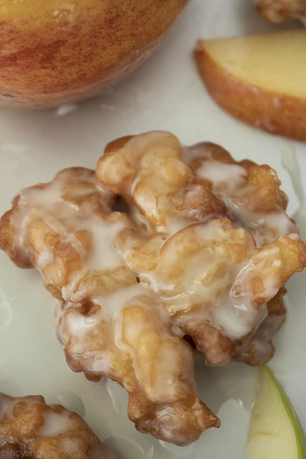 Apple Fritter on a stainless pan with apple slices around