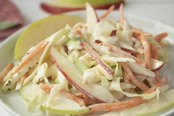 Horizontal image of creamy apple slaw on a white plate