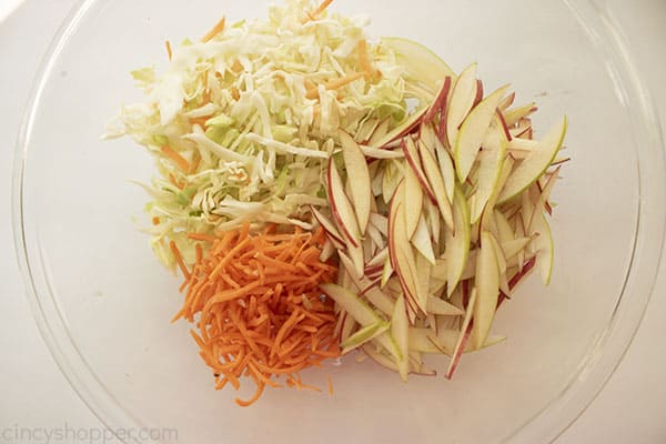 apple coleslaw ingredients in a clear bowl