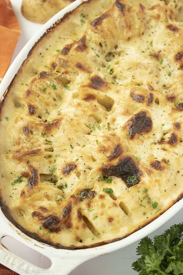 Baked Au Gratin Potato casserole in white baking dish.