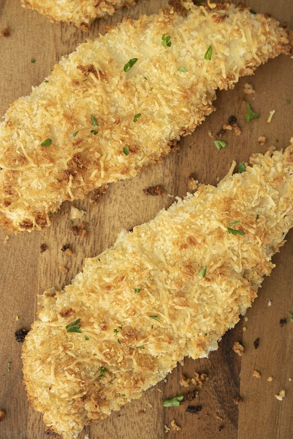 baked chicken tenders on a dark cutting board