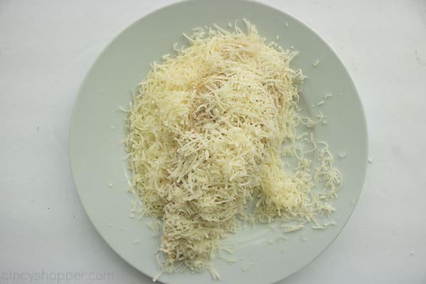 Dredged chicken tender in Parmesan cheese on a white plate