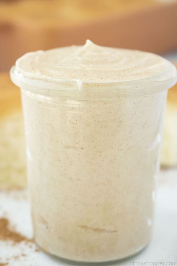 Cinnamon Butter in a clear jar with rolls in the background