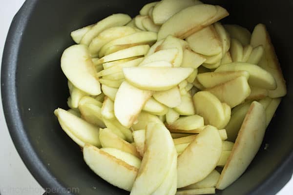 Sliced apples in a dark pot.