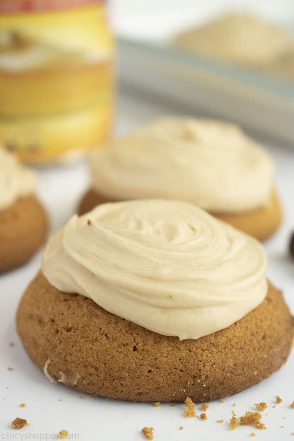 Pumpkin Cookies with brown butter frosting on a white background 3 cookies shown with canned pumpkin
