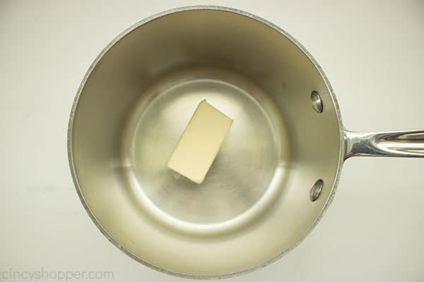 Butter in a small saucepan with white background