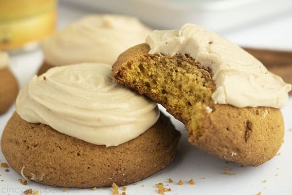 Image with two Pumpkin Cookies with brown butter frosting on a white background