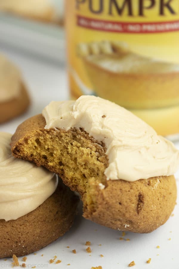 Pumpkin Cookie with a bite on a white background with canned pumpkin behind