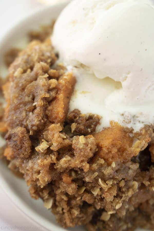 Closeup of crisp on a white plate and vanilla ice cream on top