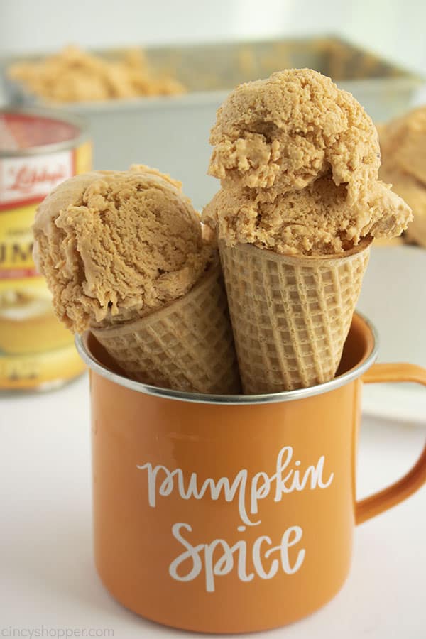 Two pumpkin ice cream cones in a orange mug with Pumpkin Spice text