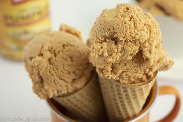 Two pumpkin ice cream cones in a orange mug