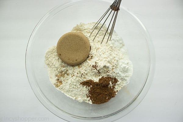 Streusel ingredients in a clear bowl with whisk
