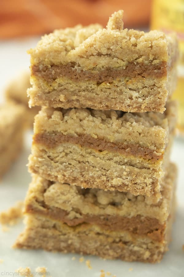 Stack of three Pumpkin Bars with orange napkin in the background