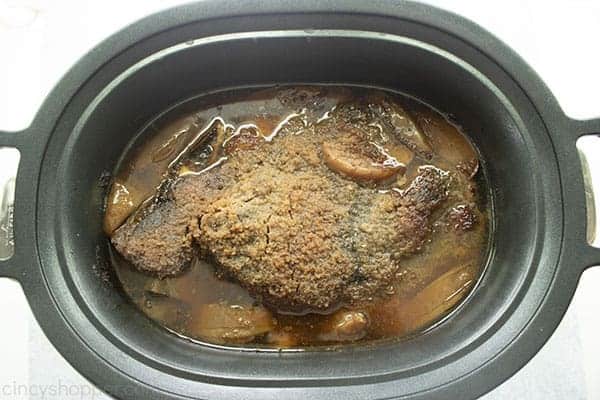 Overhead photo of the cooked Apple Cider Pulled Pork in the black Slow Cooker 
