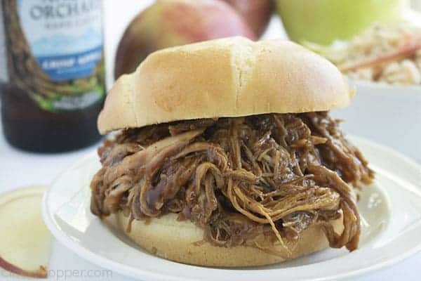 Plated Apple Cider Pulled Pork Sandwich on a white plate 